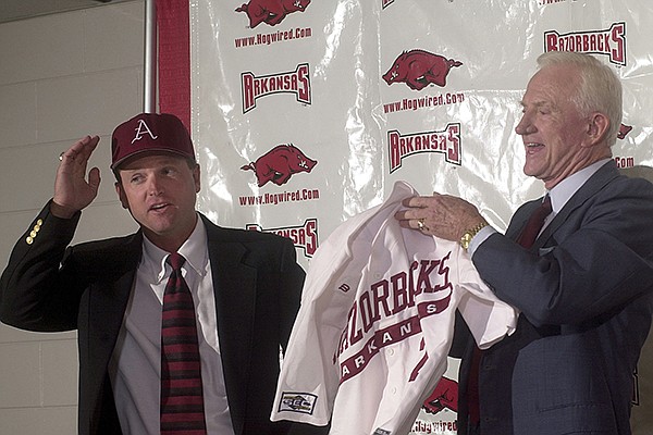 Arkansas baseball coach Dave Van Horn (left) is introduced by athletics director Frank Broyles at a news conference Friday, June 21, 2002, at Bud Walton Arena in Fayetteville. 