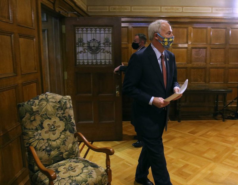 Gov. Asa Hutchinson enters the room before the daily covid-19 briefing on Thursday, May 21, 2020, at the state Capitol in Little Rock. 
(Arkansas Democrat-Gazette/Thomas Metthe)