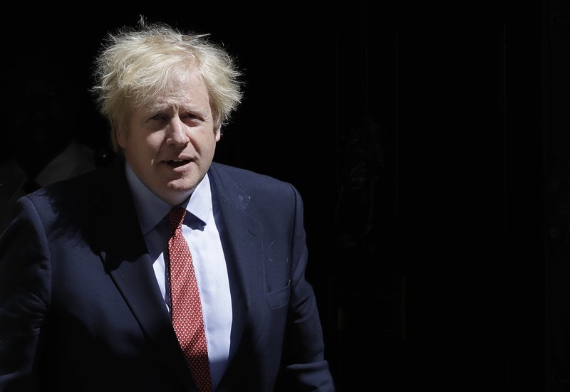 Britain's Prime Minister Boris Johnson leaves Downing Street to attend the weekly session of PMQs in Parliament in London as the country continues its lockdown to help stop the spread of coronavirus, Wednesday, May 20, 2020. (AP Photo/Kirsty Wigglesworth)