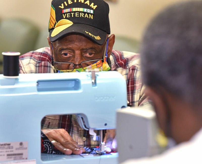 Veteran Albert Hunter concentrates on his sewing technique while learning to make masks for other veterans during a Creative Expression class in North Little Rock. Photo courtesy of CAVHS VAVS Chief Michael R. Dobbs.