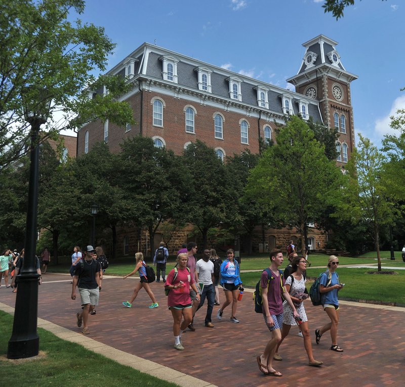 University of Arkansas students walk past Old Main Sept. 3, 2014 on in Fayetteville.