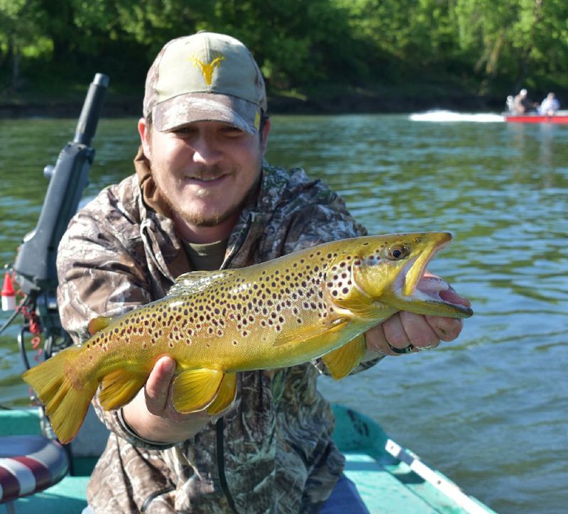 Craig Yowell, a trout shing guide on the White River, displays a 21-inch rainbow trout (left) and a 22-inch brown trout that the author caught and released Monday on the White River. The author also caught 17-inch and 21-inch brown trout. More photos are available at arkansasonline.com/524trip/. (Arkansas Democrat-Gazette/Bryan Hendricks) 
