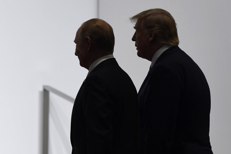 In this June 28, 2019, file photo, President Donald Trump and Russian President Vladimir Putin walk to participate in a group photo at the G20 summit in Osaka, Japan.  (AP Photo/Susan Walsh, File)