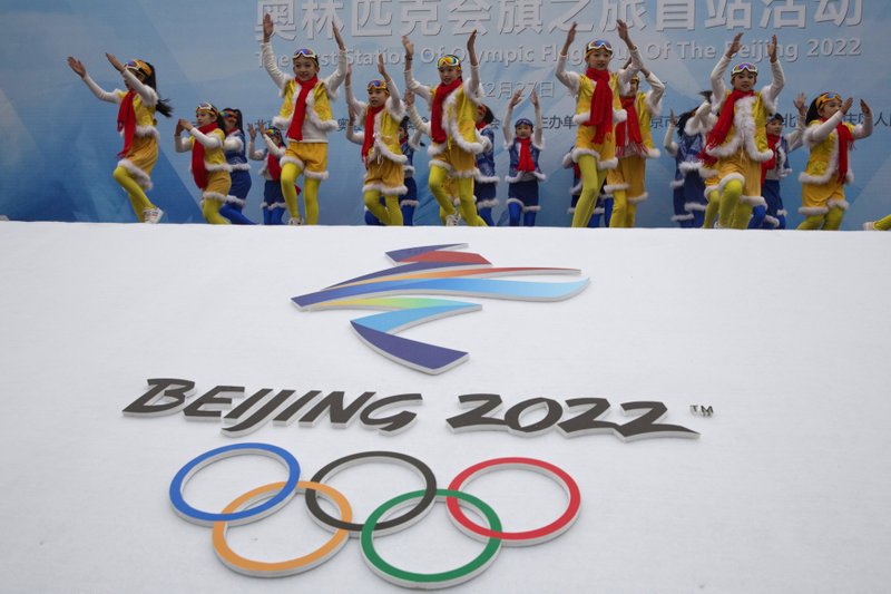 Chinese performers dance during a Feb. 27, 2018, ceremony to mark the arrival of the Olympic flag and start of the flag tour for the Winter Olympic Games Beijing 2022 at a section of the Great Wall of China on the outskirts of Beijing. Uncertainty surrounds how the postponed Tokyo Olympics will be held next year in the midst of the coronavirus. The same questions permeate three mega-events that will be staged in China within a year after the Tokyo Games close. - Photo by Ng Han Guan of The Associated Press