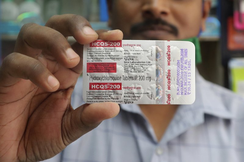 In this Tuesday, May 19, 2020 file photo, a chemist holds a pack of hydroxychloroquine tablets in Mumbai, India. A Friday, May 22, 2029 report in the journal Lancet shows malaria drugs pushed by U.S. President Donald Trump as treatments for the coronavirus not only did not help but were tied to a greater risk of death and heart rhythm problems in a study of nearly 100,000 patients around the world. (AP Photo/Rafiq Maqbool)