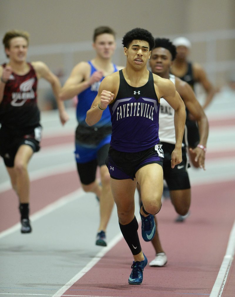 Isaiah Sategna (center) of Fayetteville leads the field in the 400 meters during the 5A/6A State Indoor Track and Field Championships at the Randal Tyson Track Center in Fayetteville. Sategna had his outdoor season at Fayetteville canceled because of concerns about the spread of covid-19. (NWA Democrat-Gazette/Andy Shupe)