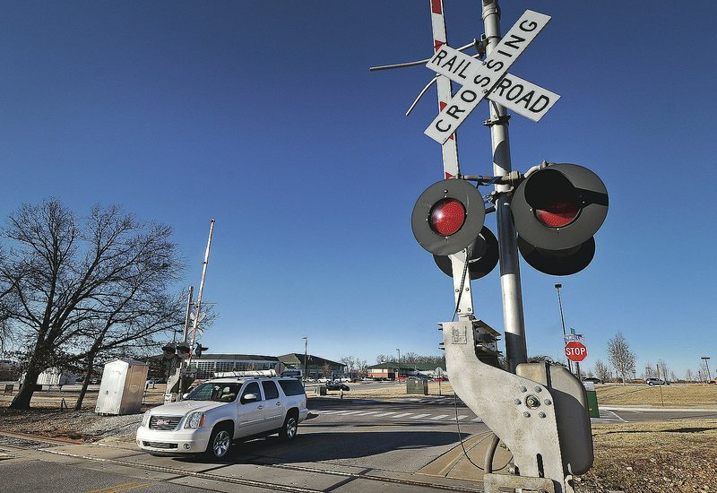 A vehicle crosses the railroad tracks that once bisected the Northwest Arkansas Community College campus in Bentonville in 2014. (File Photo/NWA Democrat-Gazette/Ben Goff)