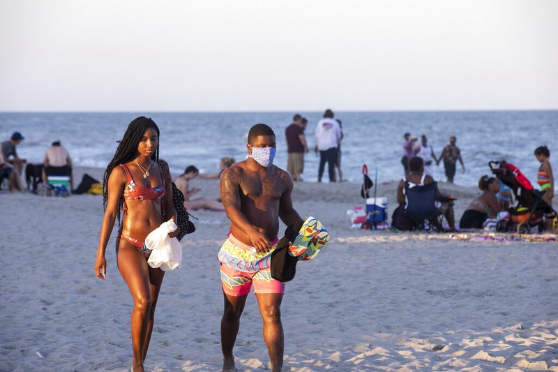 Sunbathers catch the last rays of evening light, amid the coronavirus pandemic, Saturday, May 23, 2020, in Myrtle Beach, S.C. (Jason Lee/The Sun News via AP)