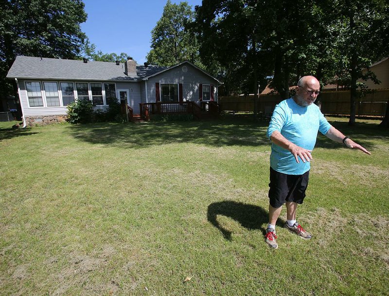 Mayflower resident Ian McGrath (shown) talks Thursday about how high the water got in the backyard of his home last year when Lake Conway flooded. 
(Arkansas Democrat-Gazette/Thomas Metthe)