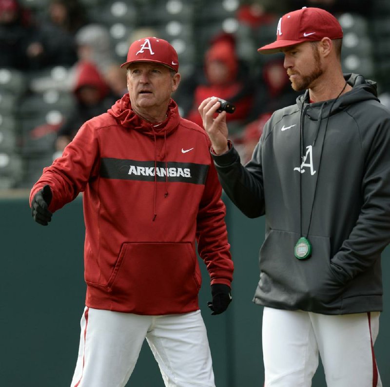 NWA Democrat-Gazette/ANDY SHUPE
Arkansas coach Dave Van Horn speaks to pitching coach Matt Hobbs against Eastern Illinois Saturday, Feb. 16, 2019, during the seventh inning at Baum-Walker Stadium in Fayetteville. Visit nwadg.com/photos to see more photographs from the games.