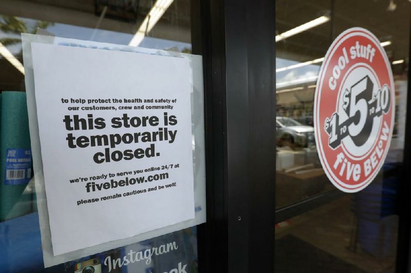 In this photo taken in late April, a sign is posted on a closed store in North Miami, Fla.
(AP/Wilfredo Lee)