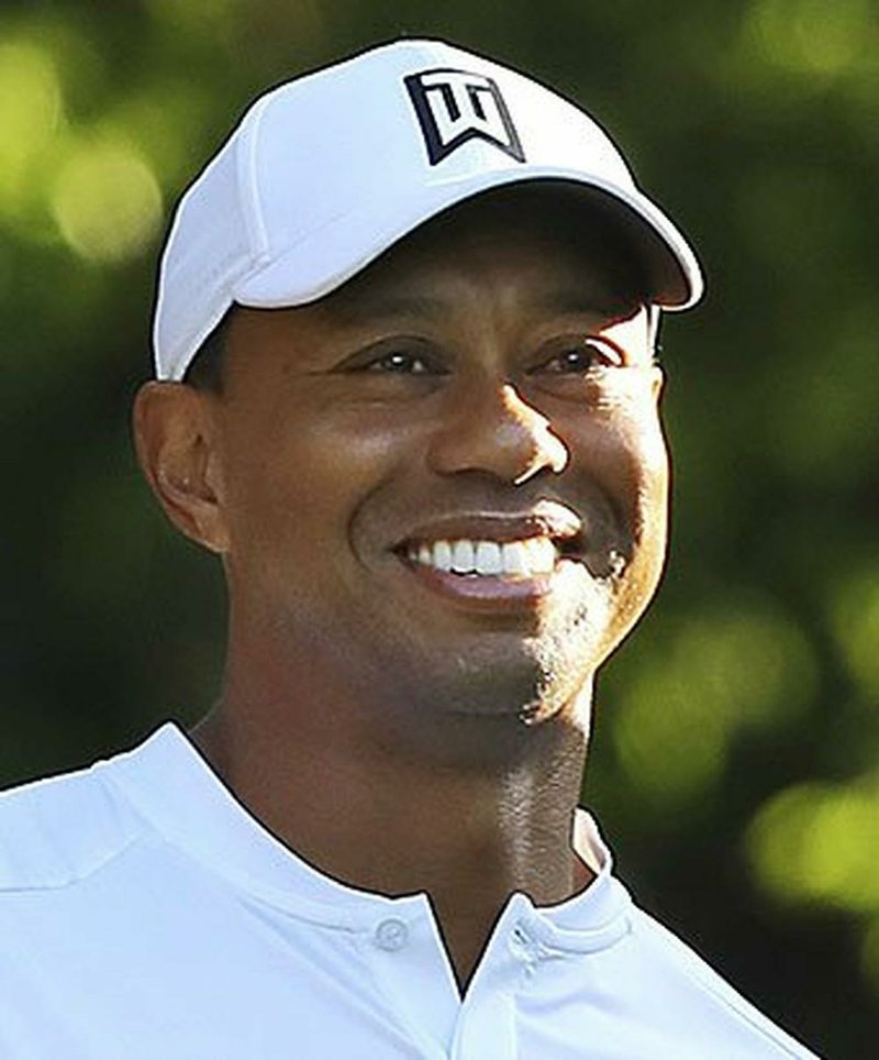 FILE - In this April 3, 2018, file photo, Tiger Woods, left, and Phil Mickelson share a laugh on the 11th tee box while playing a practice round for the Masters golf tournament at Augusta National Golf Club in Augusta, Ga. The next match involving Tiger Woods and Phil Mickelson involves a $10 million donation for COVID-19 relief efforts, along with plenty of bragging rights in a star-powered foursome May 24 at Medalist Golf Club. Turner Sports announced more details Thursday, May 7, 2020, for “The Match: Champions for Charity,†a televised match between Woods and Peyton Manning against Mickelson and Tom Brady. (Curtis Compton/Atlanta Journal-Constitution via AP, File) story.lead_photo.caption