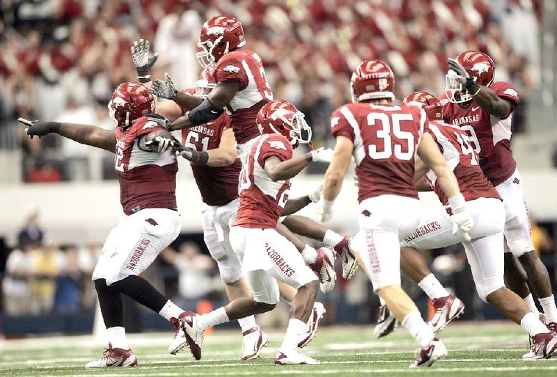The Arkansas defense celebrates after stopping Texas a&M on fourth down late in the fourth quarter of the Razorbacks’ 42-38 victory over the aggies on Oct. 1, 2011, in arlington, Texas. (Arkansas democrat-Gazette file photo) 