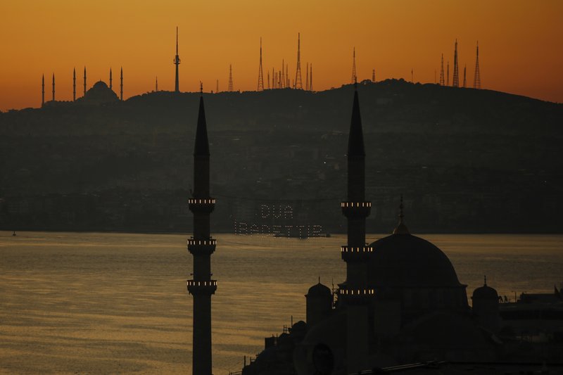 Mosques are seen as few masked people allowed to offer the Eid al-Fitr prayer amid concerns of the coronavirus outbreak at historical Suleymaniye Mosque, in Istanbul, early Sunday, May 24, 2020. Muslims in the world are marking a muted and gloomy religious festival of Eid al-Fitr, the end of the fasting month of Ramadan _ a usually joyous three-day celebration that has been significantly toned down due to the new coronavirus outbreak.(AP Photo/Emrah Gurel)