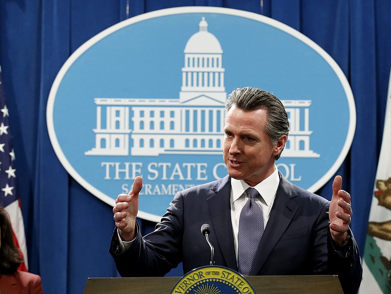  In this March 12, 2020, file photo, California Gov. Gavin Newsom speaks to reporters about his executive order advising that non-essential gatherings of more than 250 people should be canceled until at least the end of March, during a news conference in Sacramento, Calif.  (AP Photo/Rich Pedroncelli, File)