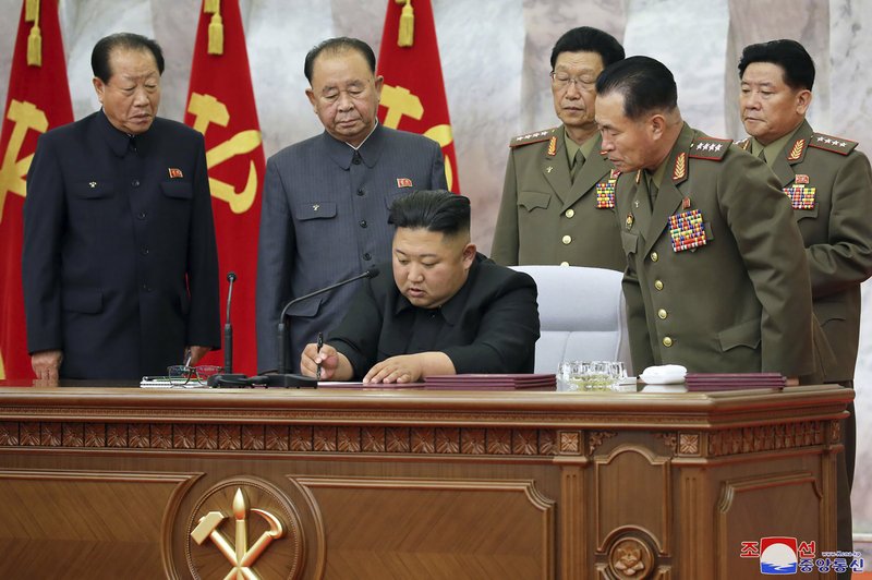 North Korean leader Kim Jong Un signs a document during the Central Military Commission meeting. (AP/Korean Central News Agency/Korea News Service)