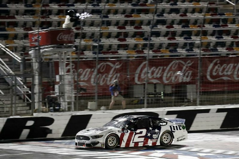 Brad Keselowski crosses the finish line to win the NASCAR Cup Series race Sunday at Charlotte Motor Speedway in Concord, N.C. Keselowski held off seven-time NASCAR champion Jimmie Johnson in overtime for his first victory of the season. 
(AP/Gerry Broome) 