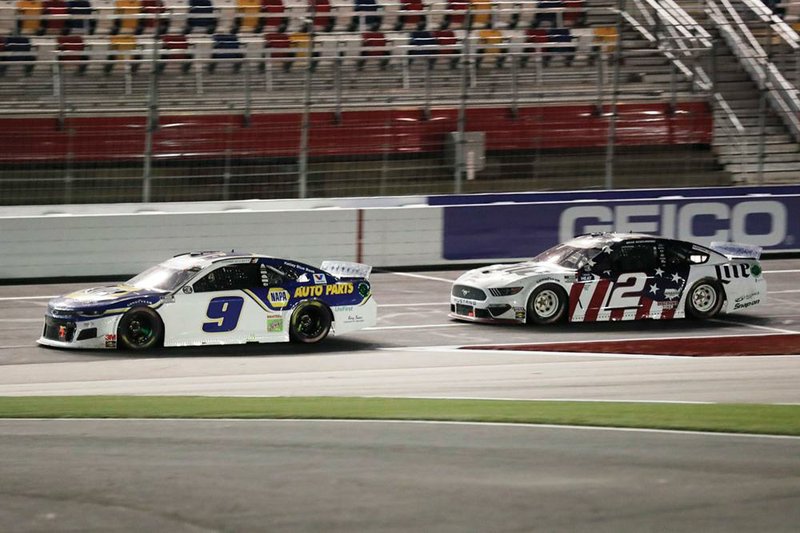 Chase Elliott (left) leads Brad Ke- selowski during Sunday’s NASCAR Cup Series race 
at Charlotte Motor Speedway in Con- cord, N.C. Elliott came in second behind Keselowski in an overtime finish. 
(AP/Gerry Broome) 
