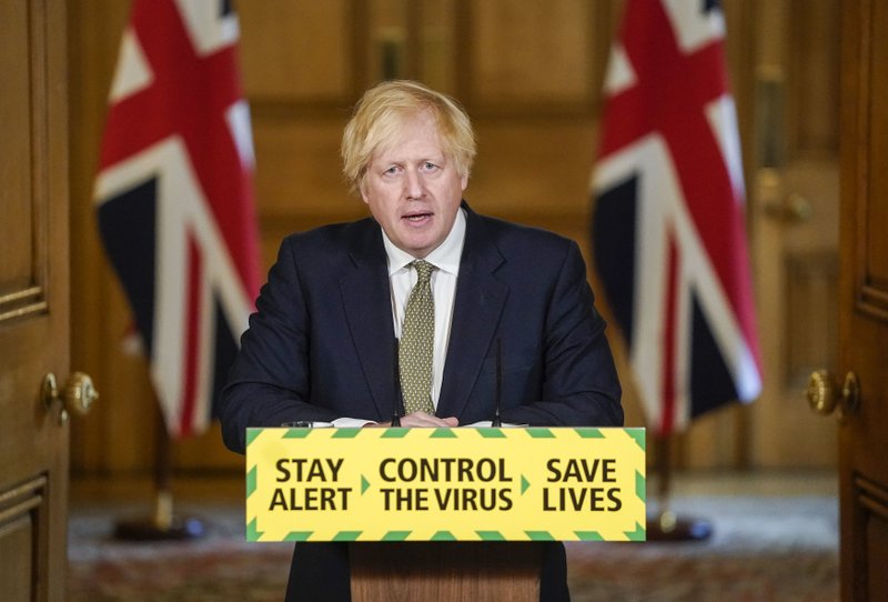 In this photo issued by 10 Downing Street, Britain's Prime Minister Boris Johnson speaks during a media briefing on coronavirus in Downing Street, London, Sunday May 24, 2020. Boris Johnson says he won't fire his chief aide Dominic Cummings for allegedly violating the national coronavirus lockdown rules that he helped to create. (Andrew Parsons/10 Downing Street via AP)