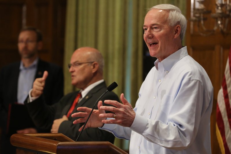 FILE -- Gov. Asa Hutchinson (right) answers a question during the daily covid-19 briefing on Saturday, May 23, 2020, at the state Capitol in Little Rock.
(Arkansas Democrat-Gazette/Thomas Metthe)
