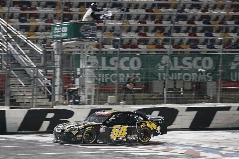 Kyle Busch crosses the finish line to win the NASCAR Xfinity Series race Monday night in Concord, N.C. Busch passed Austin Cindric on the final lap to take the lead. (AP/Gerry Broome) 