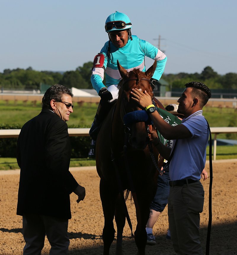 Arkansas Democrat-Gazette/Thomas Metthe ARKANSAS DERBY CONTROVERSY: Jim Barnes, left, assistant to trainer Bob Baffert, goes to congratulate jockey Martin Garcia, top, after Charlatan won the first division of the Arkansas Derby on May 2 at Oaklawn.