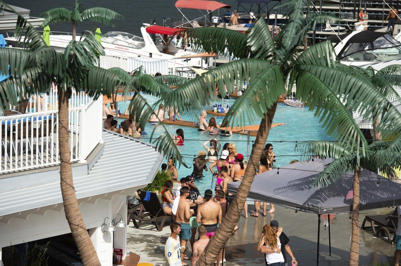 Crowds of people gather at Coconuts Caribbean Beach Bar &amp; Grill in Gravois Mills, Missouri, Sunday, May 24, 2020. Several beach bars along Lake of the Ozarks were packed with party-goers during the Memorial Day weekend. Several political leaders in the St. Louis and Kansas City areas, as well as the state of Kansas' health secretary, have condemned Lake of the Ozarks revelers for failing to practice social distancing, amid fears they could return to areas hard hit by the coronavirus and spread the disease. (Shelly Yang/Kansas City Star via AP)