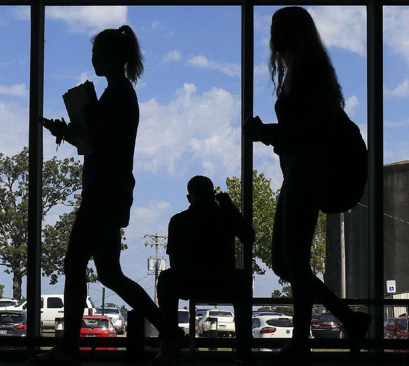 FILE — Students are shown making their way to and from classes in the Center for Humanities and Arts building on the University of Arkansas-Pulaski Technical College campus in North Little Rock in this 2019 file photo.