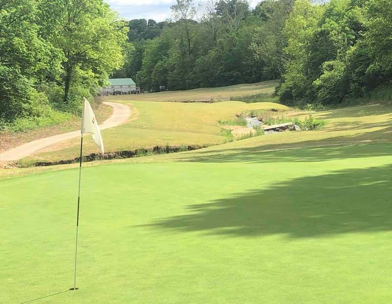 RICK PECK/SPECIAL TO MCDONALD COUNTY PRESS Looking back down the fairway on the 12th hole at Big Sugar Golf Club in Pea Ridge. The signature hole requires a second shot of 200 yards while avoiding woods on both sides and water down the middle.