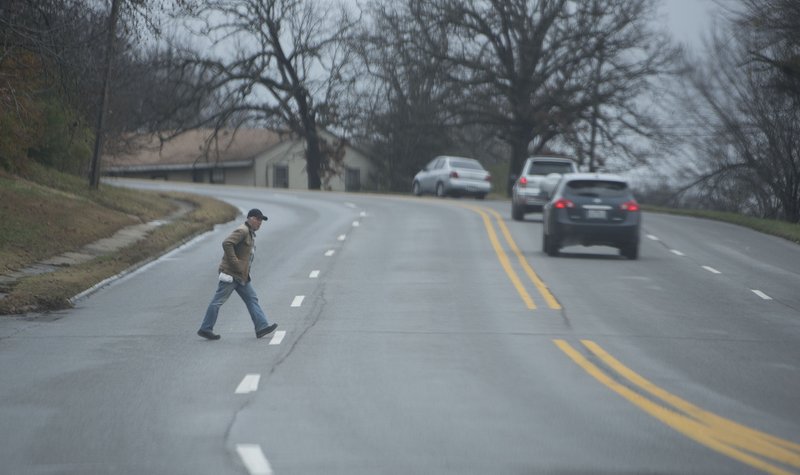 FILE -- A pedestrian crosses Archibald Yell Blvd. Nov. 30, 2015 at the Block Ave. intersection in Fayetteville. (NWA Democrat-Gazette/J.T. WAMPLER)