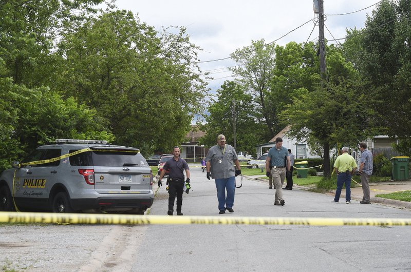 Investigators process the scene of an officer involved shooting, Thursday, May 28, 2020, at a house on Laura Street and Huntsville Avenue in Springdale. (NWA Democrat-Gazette/Charlie Kaijo)