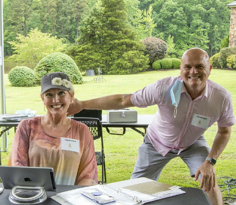 Christy Lund and Designer House Chairman Larry West check in guests. 