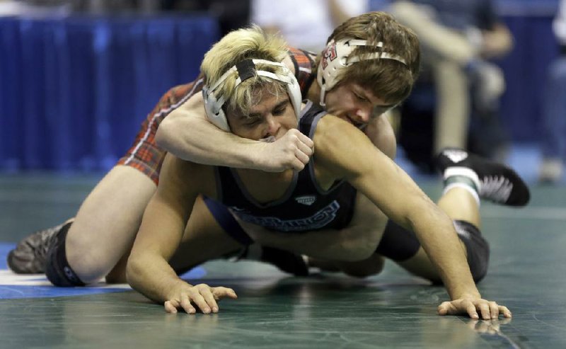 Edinboro’s Mitchell Port (right) wrestles Old Dominion’s Chris Mecate during their 141-pound semifinal at the 2015 NCAA Division I Wrestling Championships in St. Louis. Old Dominion said in early April it would discontinue wrestling, a decision affecting 32 athletes and saving about $1 million.
(AP file photo)