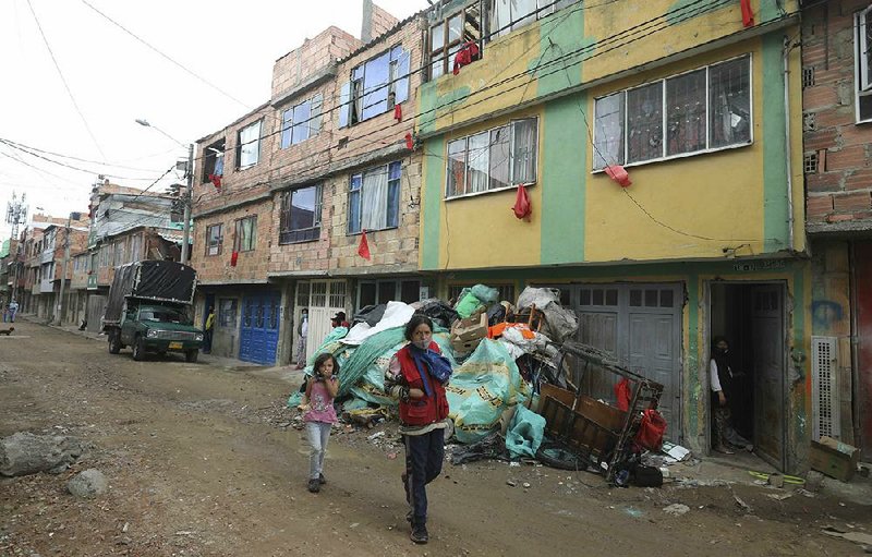 Pieces of red fabric hang from the windows of Colombians in need of food Wednesday to alert Bogota city employees who will deliver bags of free food amid a lockdown across the city.
(AP/Fernando Vergara)