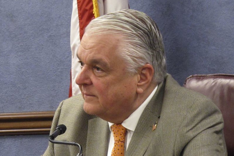 In this May 7, 2020, file photo, Nevada Gov. Steve Sisolak listens to a reporter's question during a news conference in Carson City, Nev. The Trump administration is warning Nevada's Democratic governor that his plan for reopening the state during recovery from the coronavirus fails to treat religious and secular gatherings equally.  (AP Photo/Scott Sonner, File)
