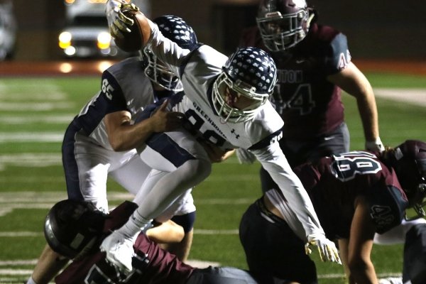 Greenwood wide receiver Peyton Carter (88) hurdles Benton safety Dylan Burnham (14) during the second quarter on Friday, Oct. 25, 2019, at Panther Stadium in Benton.