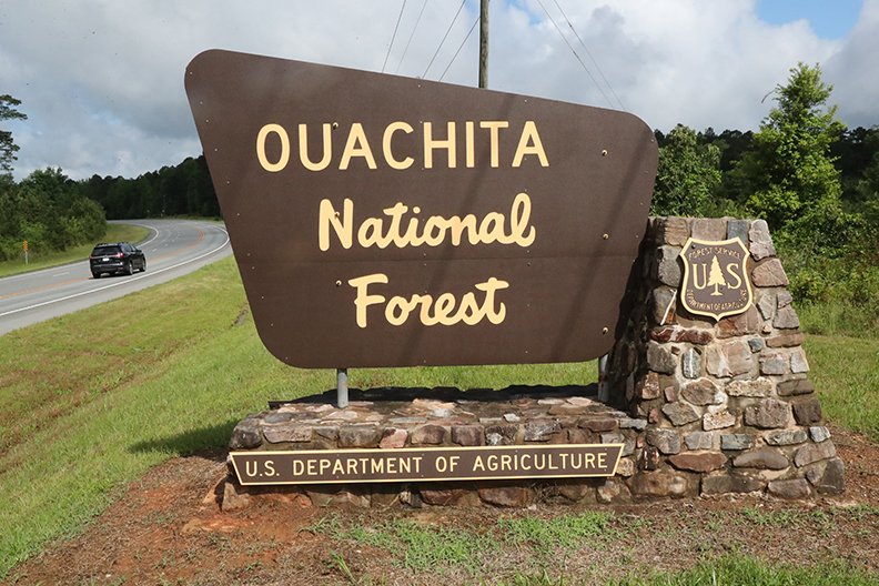 A motorist heads west into the Ouachita National Forest on Highway 270 west of Hot Springs on Thursday. Some day-use areas on the forest have reopened. - Photo by Richard Rasmussen of The Sentinel-Record