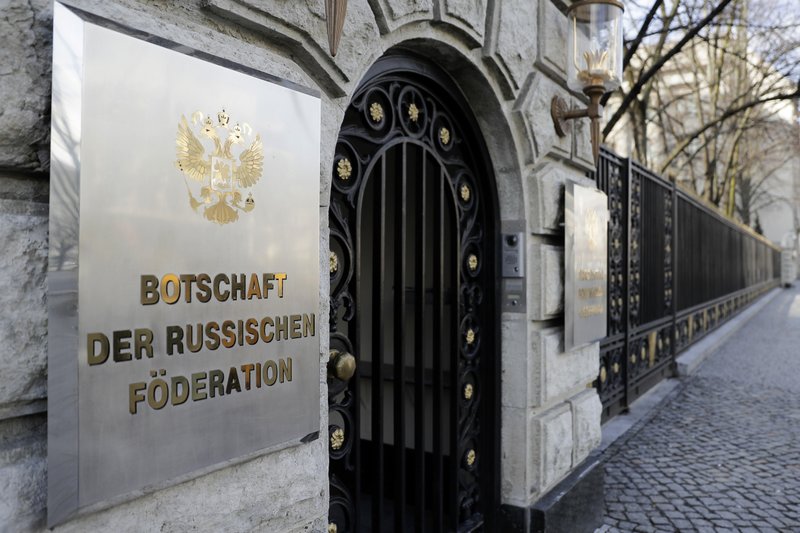 in this March 27, 2018 file photo a sign reading 'Embassy of the Russian Federation' displayed at entrance of the Russian embassy in Berlin, Germany. Germany said Thursday it is seeking EU sanctions against a Russian man over his alleged role in the hacking of the German parliament at a time when evidence shows he was working for Russian intelligence.  (AP Photo/Markus Schreiber)