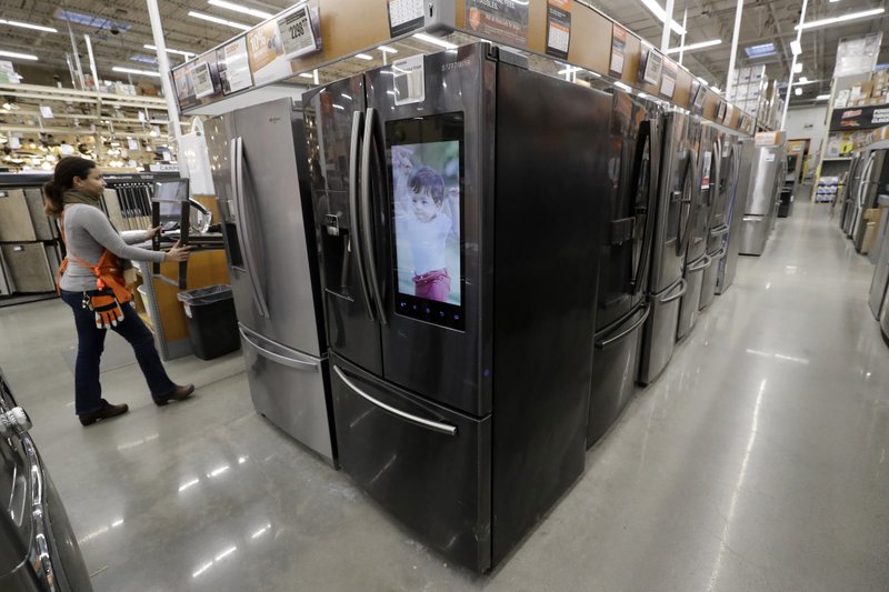  In this Jan. 27, 2020 file photo a worker pushes a cart past refrigerators at a Home Depot store location in Boston. On Thursday, May 28, the Commerce Department released its April report on durable goods. (AP Photo/Steven Senne)