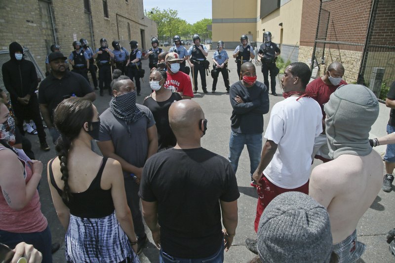 Protesters face off with police at the Minneapolis Police Third Precinctt, Thursday, May 28, 2020, after a night of rioting as protests continue over the arrest of George Floyd who died in police custody Monday night in Minneapolis after video shared online by a bystander showed a white officer kneeling on his neck during his arrest as he pleaded that he couldn't breathe. (AP Photo/Jim Mone)