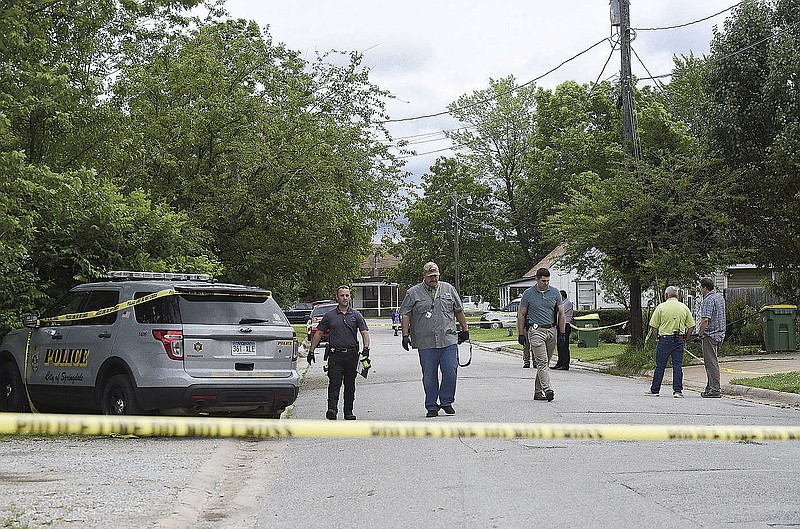 Investigators process the scene of an officer-involved shooting Thursday at a house on Laura Street and Hunstville Avenue in Springdale. Go to nwaonline.com/200529Daily/ for today's photo gallery. (NWA Democrat-Gazette/Charlie Kaijo)