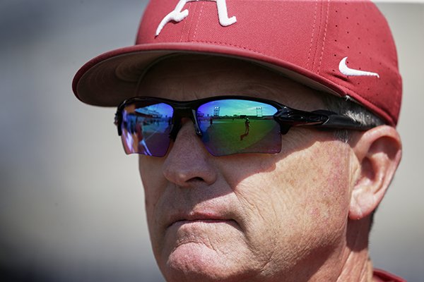 TD Ameritrade Park, home of the College World Series, is reflected in the sunglasses of Arkansas NCAA college baseball coach Dave Van Horn during team practice in Omaha, Neb., Friday, June 14, 2019. (AP Photo/Nati Harnik)