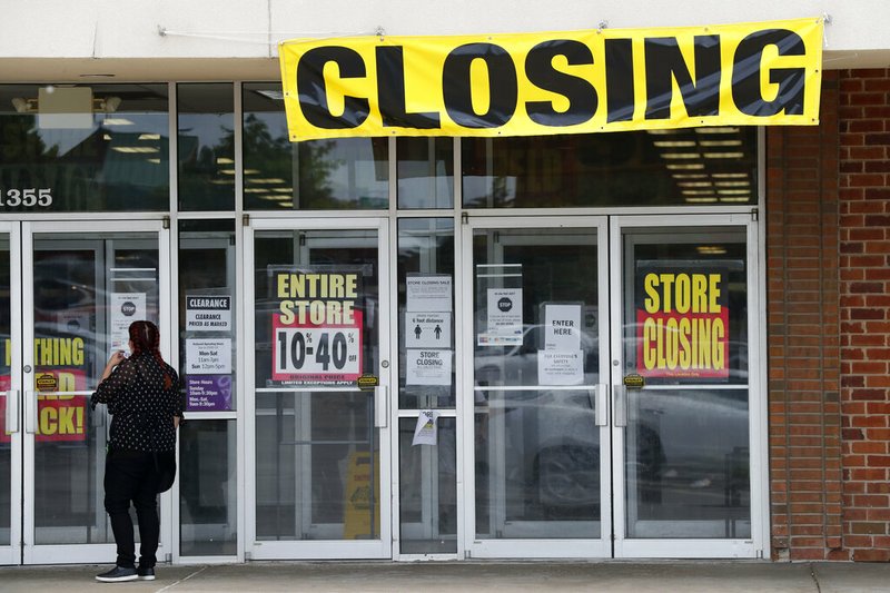 A woman walks into a closing Gordmans store, Thursday, May 28, 2020, in St. Charles, Mo. Stage Stores, which owns Gordmans, is closing all its stores and has filed for Chapter 11 bankruptcy. (AP Photo/Jeff Roberson)