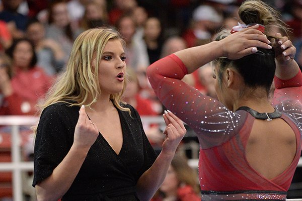 Arkansas interim assistant coach Catelyn Orel speaks Friday, Feb. 7, 2020, with Jessica Yamzon during the Razorbacks' meet with Georgia in Barnhill Arena in Fayetteville.
