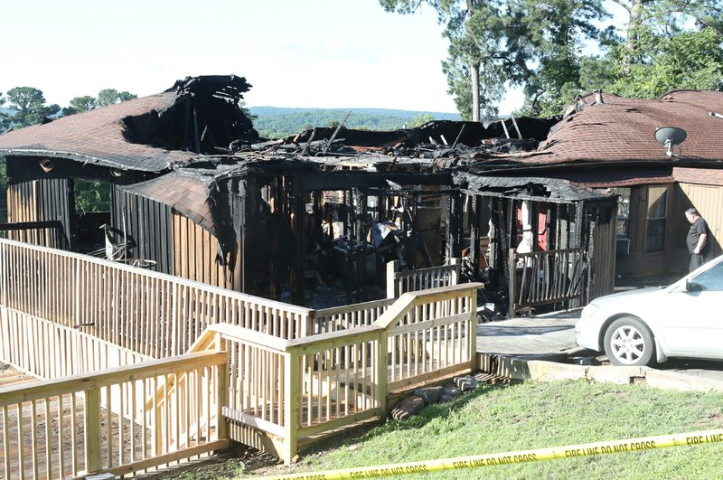 Fire destroyed several units on the top floor of a condominium complex on Highway 7 south at Hamilton Oaks Drive early Friday morning. - Photo by Richard Rasmussen of The Sentinel-Record