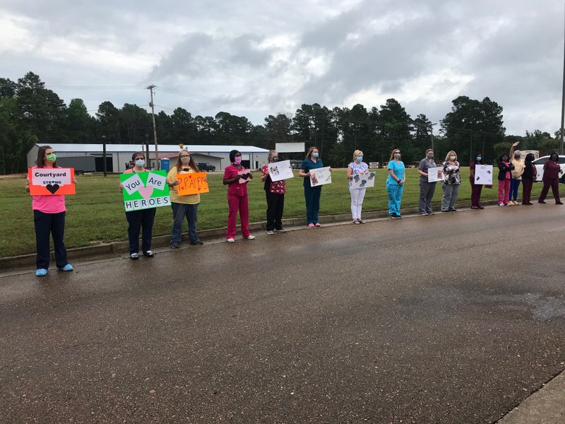 Area nursing homes gathered for prayer around Courtyard today to show their support and give them praise for all their hard work during this difficult time. Shown in photo are employees from Hudson Nursing Home and Advanced Care and Rehab.