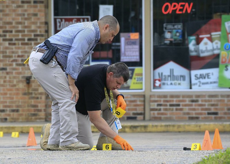 North Little Rock police Thursday investigate an officer-involved shooting at 4615 E. Broadway. More photos at arkansasonline.com/529shooting/.
(Arkansas Democrat-Gazette/Staton Breidenthal)
