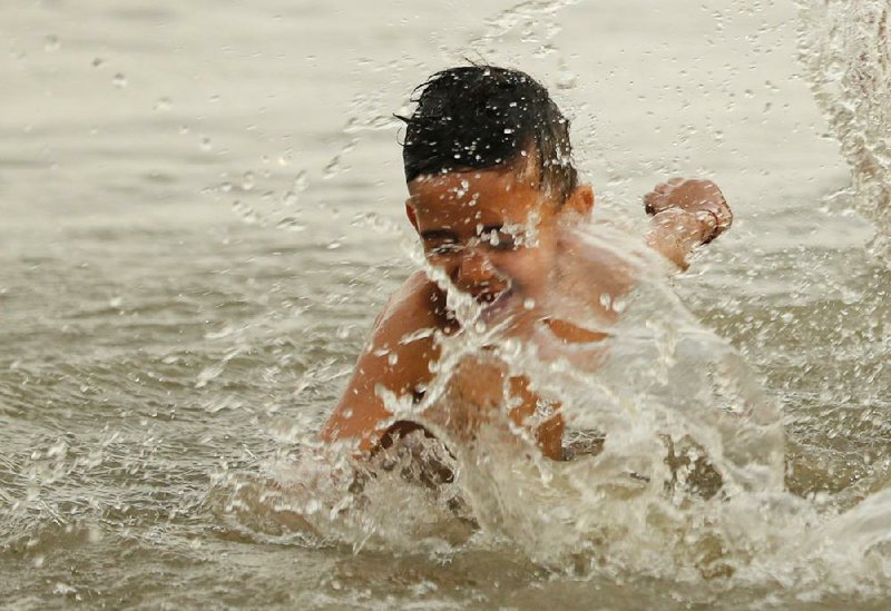 A boy bathes in the Ganges River on a hot summer day Wednesday in Prayagraj, India. More photos at arkansasonline.com/529india/.
(AP/Rajesh Kumar Singh)