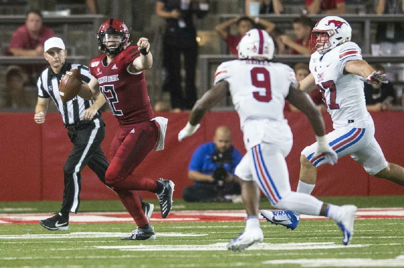 Arkansas State’s Logan Bonner (12) looks to pass during a game last season. The school will allow football players back on campus starting Monday.
(Arkansas Democrat-Gazette file photo)