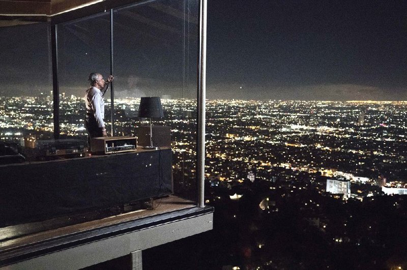 Police detective Harry Bosch (Titus Welliver) surveys his Los Angeles from his living room in a scene from the Amazon Prime series Bosch. The Hollywood Hills house is real, though in his books and the TV series, author Michael Connelly gave it a fictional address. How does a (presumably honest) police officer afford such an expensive (the property is valued at more than $2 million) view? Well, per the storyline in the show and the novels, Bosch cashed in when Paramount made a movie based upon one of his cases.